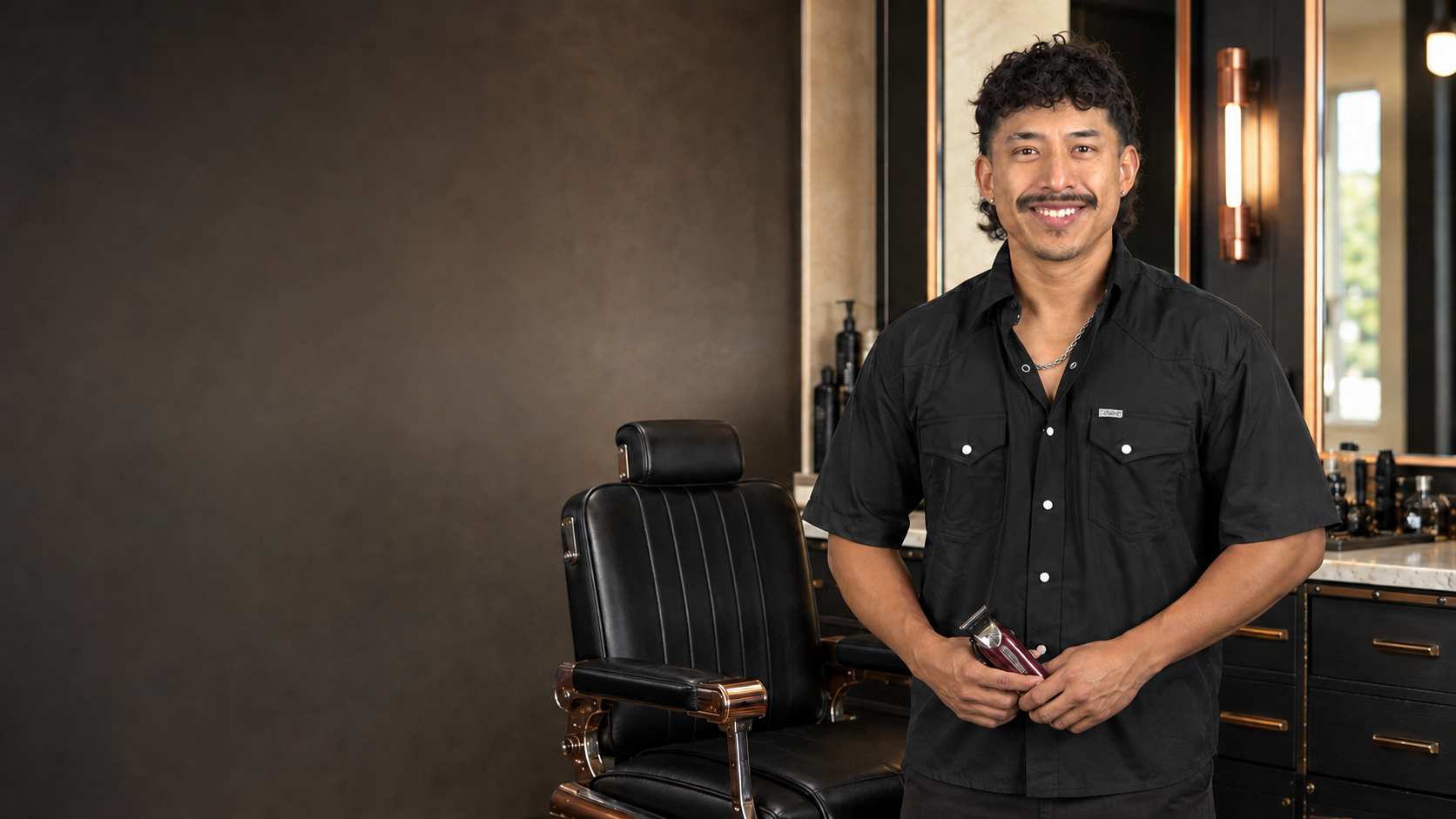 Jorge standing beside his barber chair